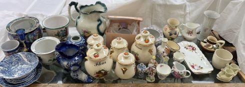 A collection of pottery storage jars together with decorative figures, vases,