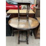 A 20th century walnut gateleg dining table on tapering legs and splayed feet together with an oak