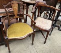 A pair of Edwardian mahogany elbow chairs with pad seats on square tapering legs and spade feet