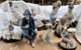 Various Nao porcelain figures including a fisherman smoking a pipe, young lady and kitten,