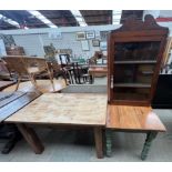 A pine kitchen table together with another pine table and a hanging corner cabinet