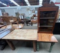 A pine kitchen table together with another pine table and a hanging corner cabinet