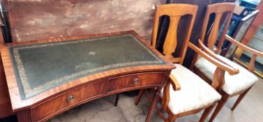 A reproduction mahogany desk together with a pair of elbow chairs