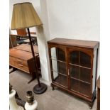 A 20th century walnut display cabinet on cabriole legs and pad feet together with a standard lamp