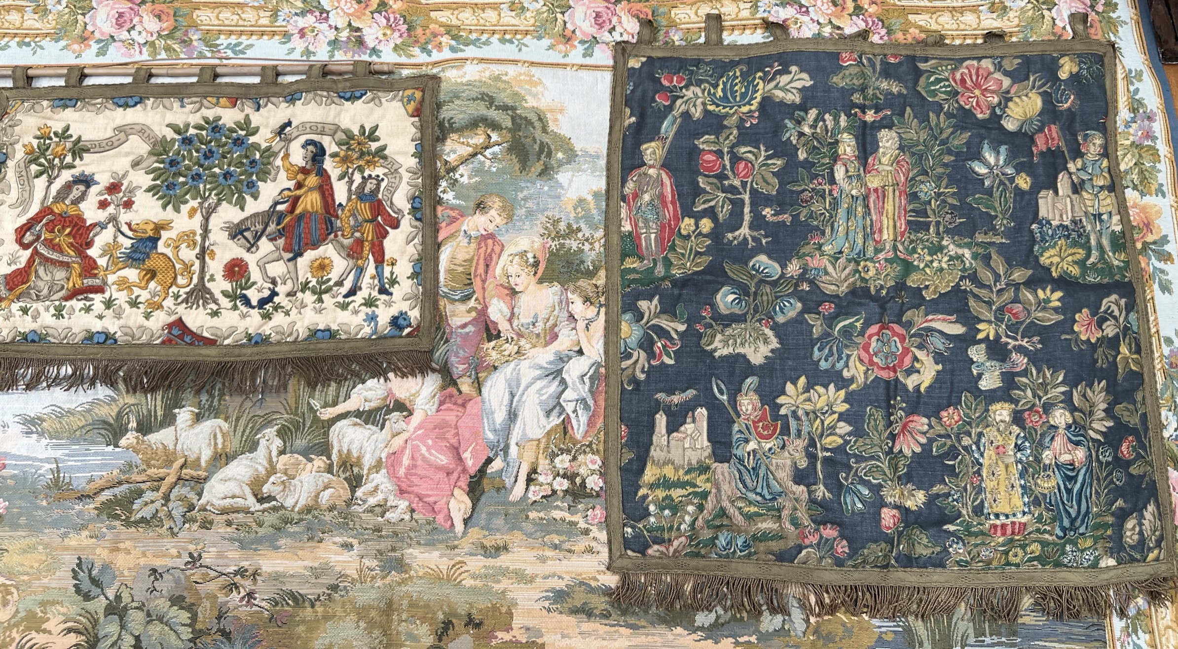 A Belgian tapestry wall hanging together with two smaller wall hangings