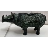 A Zhou style bronze rhinoceros, with scrolling decoration,