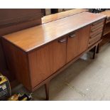 A G-plan teak sideboard, of rectangular form with two cupboards and four drawers on tapering legs,