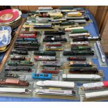 A collection of N gauge locomotives all fixed to track displays