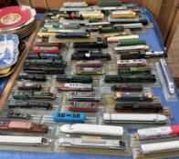 A collection of N gauge locomotives all fixed to track displays