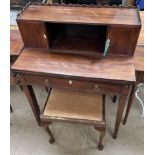 An Edwardian mahogany lady's writing table with a raised superstructure having two cupboards,