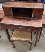 An Edwardian mahogany lady's writing table with a raised superstructure having two cupboards,