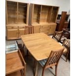 An Ercol dining suite comprising an extending dining table,