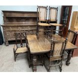 A 20th century oak extending dining suite comprising an extending dining table,
