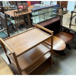 A teak tea trolley together with a teak low table, yew occasional table, bookcase,