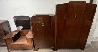 A 20th century oak three piece bedroom suite comprising two wardrobes and a dressing table
