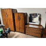 A three piece bedroom suite including wardrobes and a dressing table