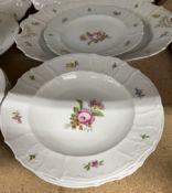 An Emil Fischer of Budapest porcelain part dinner set decorated with sprays of garden flowers