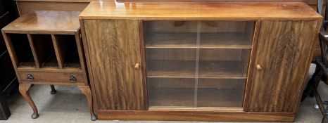 An teak display cabinet with cupboard doors and glass sliding doors together with a magazine rack