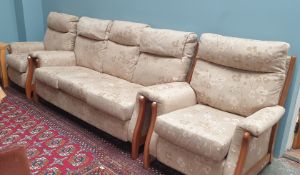 A floral upholstered three piece suite comprising a three seater settee and two chairs