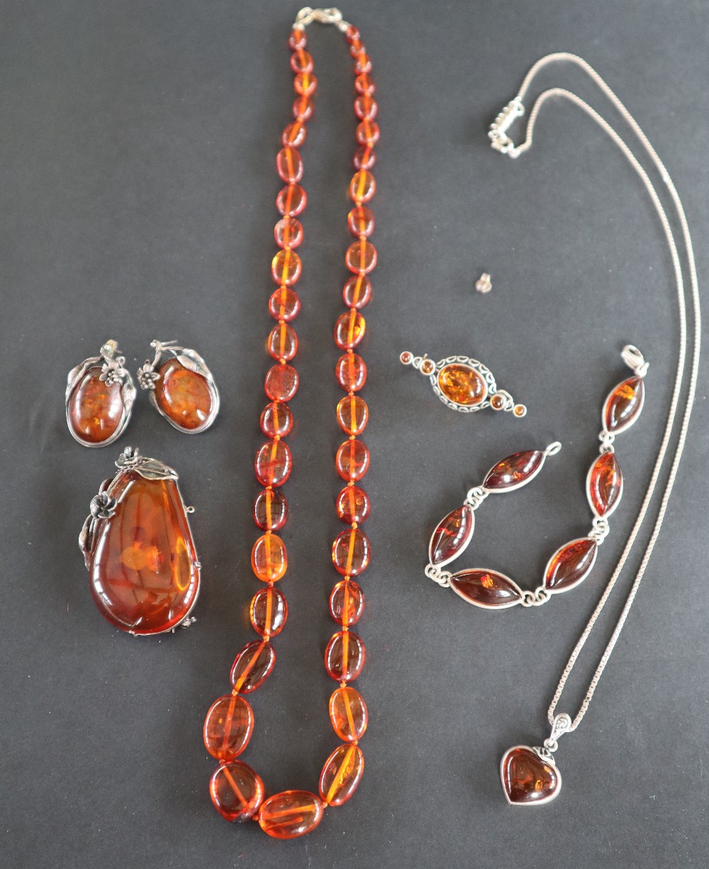 An amber necklace together with an amber pendant, a pair of amber earrings,
