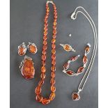 An amber necklace together with an amber pendant, a pair of amber earrings,