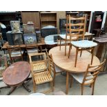 A mid 20th century teak extending dining table and six chairs together with a pair of folding