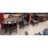 An early 20th century mahogany extending dining table together with a sideboard and six chairs