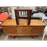 A mid 20th century teak sideboard with a set of three drawers flanked by a pair of cupboards,