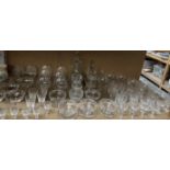 Glass decanters together with brandy balloons, champagne glasses,