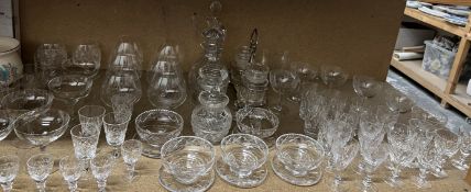 Glass decanters together with brandy balloons, champagne glasses,