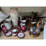 A collection of copper lustre jugs,