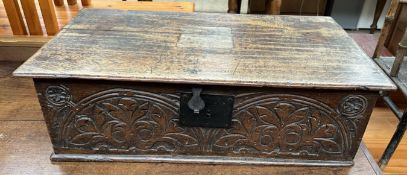 An 18th century oak bible box, with a rectangular hinged top above a carved front, 69cm wide x 37.