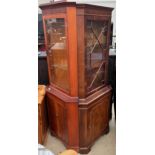 A reproduction mahogany standing corner cupboard,