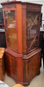 A reproduction mahogany standing corner cupboard,