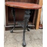 A pub table with a D shaped top on a metal base with figural terminals and shaped feet