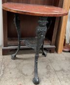 A pub table with a D shaped top on a metal base with figural terminals and shaped feet