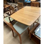 An Ercol dining suite comprising an extending dining table,