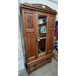 An Edwardian Satin walnut three piece bedroom suite comprising a wardrobe with a mirrored door,