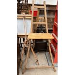 A easel with a platform and carrying handle together with another easel