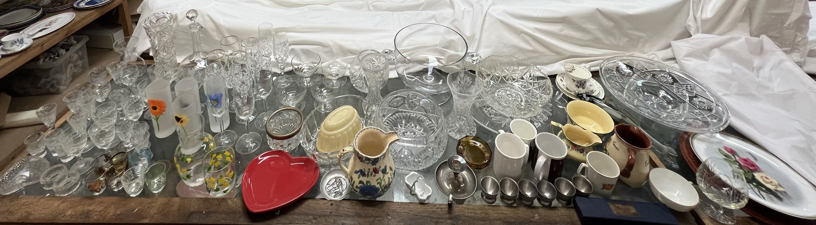 A large lot comprising a twin handled punch bowl, other glass bowls, drinking glasses, pottery mugs,