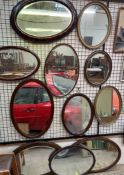 An oval gilt wall mirror together with a collection of oval wall mirrors