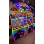 A UDC Meteor Ball arcade machine, with lit score display, prize compartments, and coin slots,