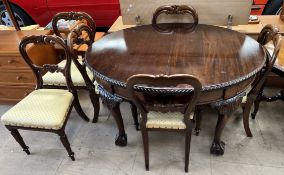 A 20th century mahogany extending dining table of oval form on leaf carved cabriole legs and claw
