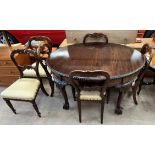 A 20th century mahogany extending dining table of oval form on leaf carved cabriole legs and claw