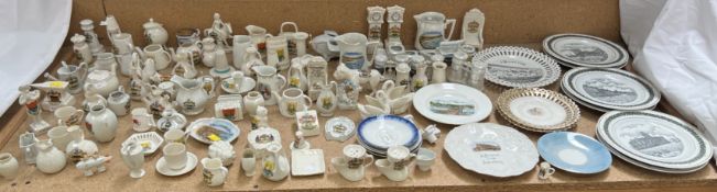 A collection of crested wares including jugs, figures, vases,