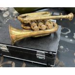 A Brass pocket trumpet, bears the stamp for Boosey, Bessons & Co.