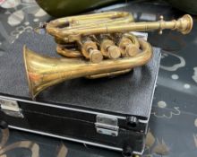 A Brass pocket trumpet, bears the stamp for Boosey, Bessons & Co.