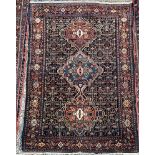 A blue ground rug with three interlocking medallions and multiple guard stripes,