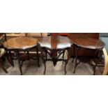 An Edwardian mahogany occasional table of shaped circular form on four shaped legs united by an