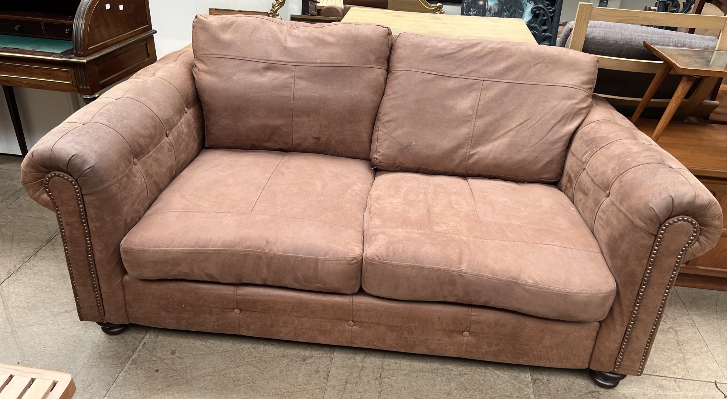 A brown leather two seater settee